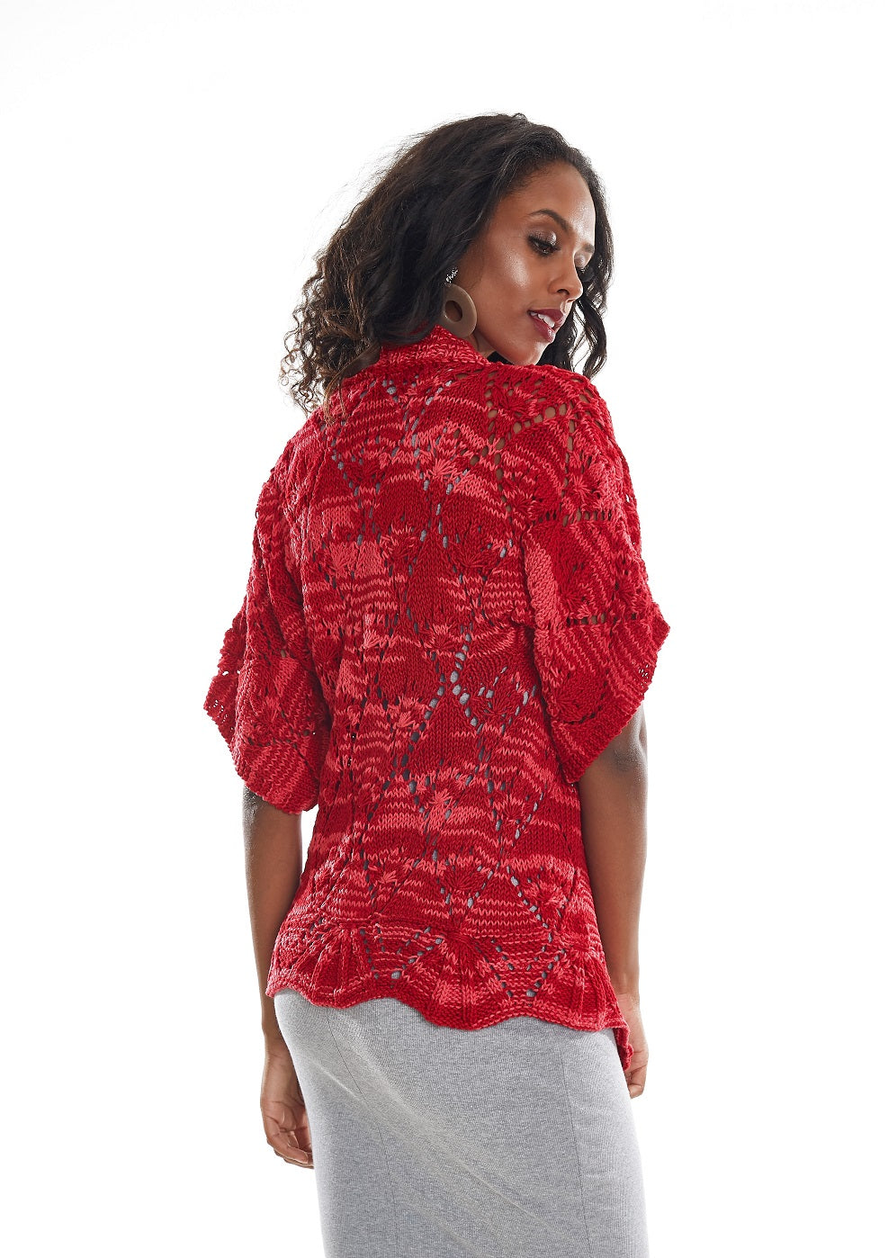 Circulo Barroco Multicolor Premium 4/6 - Brazilian Cotton Yarn, 226m/200g - A woman shown from the back wearing a red textured lace top with short sleeves and a scalloped hem, paired with a light gray skirt, against a plain white background.
