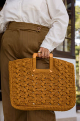 Circulo Fio Náutico Poly 5 mm – Polyester Cord Yarn ( 178 m  / 500 g) - A person wearing a white button-up shirt and brown pinstriped trousers holds a large, textured mustard-yellow crocheted tote bag with tan handles.