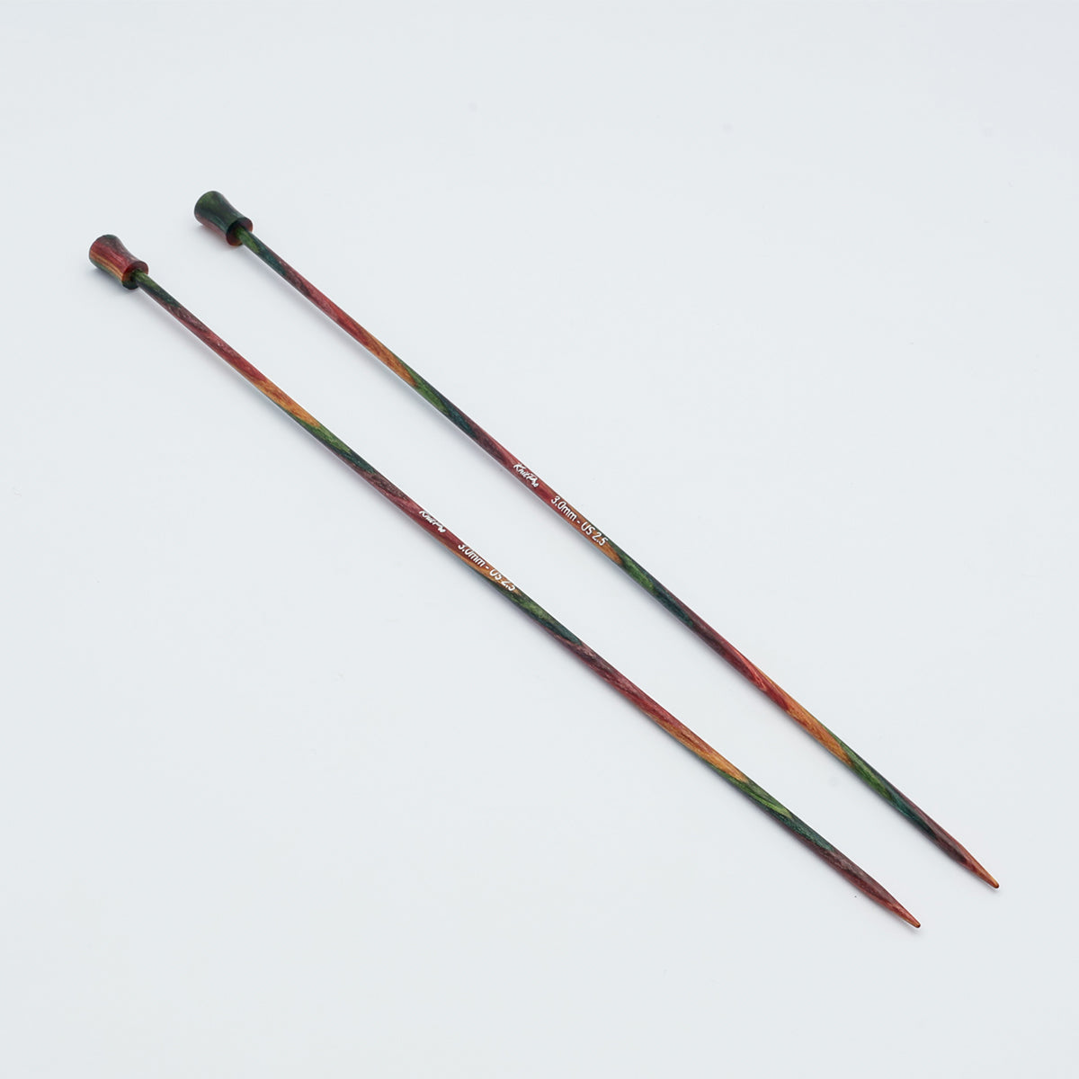KnitPro Symfonie 2 single pointed knitting needles, 25 cm - Two long knitting needles with a multicolor gradient design transitioning from dark green to red and orange, photographed on a plain white background.